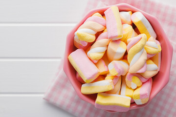 Sweet colorful marshmallows on white kitchen table.