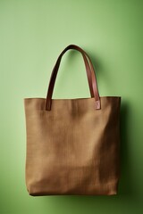 One brown tote bag on coloured background.