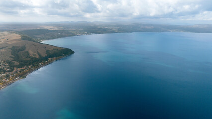 Aerial view of Lake Bracciano, originally also called Lake Sabatino. It is a lake of volcanic and tectonic origin, located in the metropolitan city of Rome and surrounded by the Sabatini Mountains.