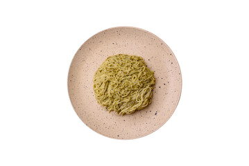 Capellini pasta or noodles with pesto sauce, salt and spices