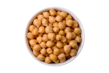 Delicious canned chickpeas in a ceramic plate on a dark concrete background