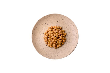 Delicious canned chickpeas in a ceramic plate on a dark concrete background