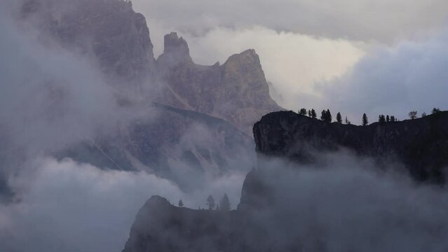 Dolomites mountains, tree and clouds