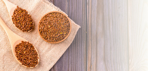 Brown flax seeds or flax seed in a small bowl on sacking