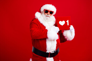 Photo of popular blogger grandfather wear trendy santa costume demonstrate social media like icon isolated on red color background