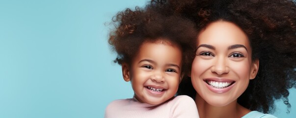 Obraz premium Mother and daughter hugging each other, smiling. Emotional portrait of a Mother and a daughter on soft colored wall.