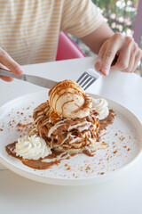 Male having pancakes with ice cream at a restaurant cafe, coffee shop.