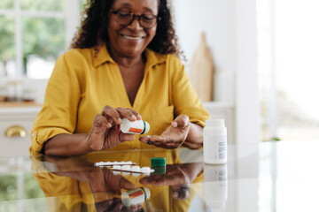 Medication adherence: Mature woman taking tablets for a chronic health condition