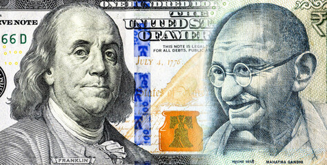 Portraits of Benjamin Franklin on banknote american dollars and Mahatma  Gandhi on Indian rupees. Business concept - 670965844