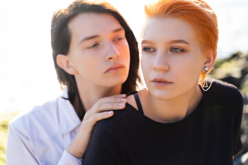 two lovers boy and girl are happy walking and hugging on the sandy beach near the sea.