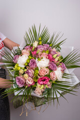 Wedding bouquet of yellow roses, white hydrangea, pink tulips and lisianthus, eucalyptus for various occasions for sale in the store