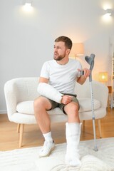 man recovery from accident fracture broken bone injury with leg splints in cast neck splints collar...