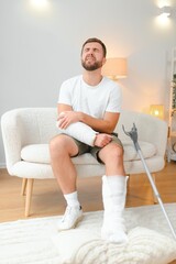 man recovery from accident fracture broken bone injury with leg splints in cast neck splints collar...