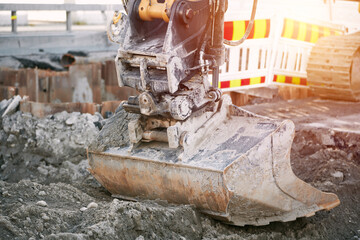 Modern construction machinery at a construction site. Scoop close up. Road construction....
