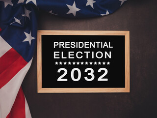 Presidential Election 2032 text on a mini blackboard over the American Flag