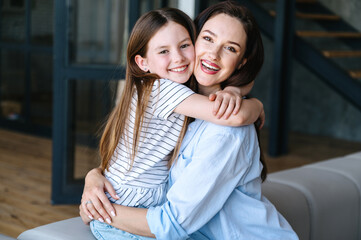 Young woman and child hugging with love, affection, tenderness.