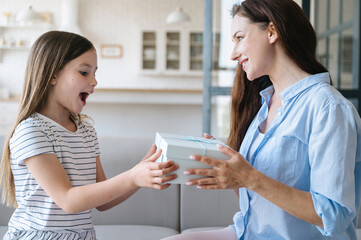Happy amazement girl receive box with gift from mother