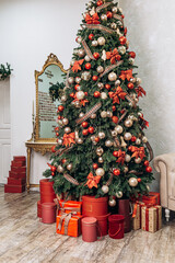 Cozy flat apartment photo studio room green Christmas Tree gifts presents garlands, candles decorated toys balls interior New Year lights glowing bokeh

