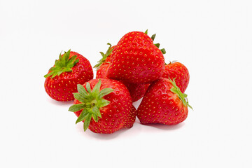 Fresh organic strawberries with green leaves isolated against white background