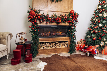 Cozy apartment, artificial electric bright fireplace with fake sparkling flame. Christmas Tree gifts presents garlands, decorated toys balls interior New Year
