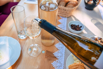 A person pouring wine to a glass