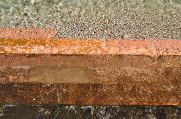 Colourful Worn Stone Steps leading into Clear Waters of Lake 