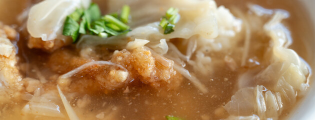 Delicious fried narrow-barred Spanish mackerel fish fillet with rice and noodles in thick soup in...