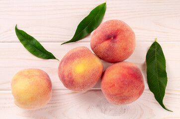 Fresh peaches on a wooden table. Summer peach fruit background.