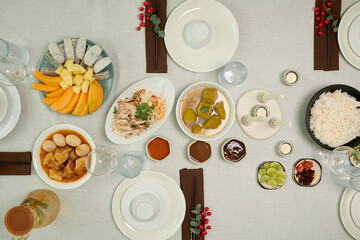 Traditional dishes, snacks and sauces on dinner table, view from above