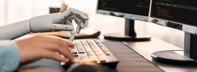 Program coding automation by generative artificial intelligence or AI concept. Collaboration between robotic hand and human software developer solving, debugging or writing script.Trailblazing