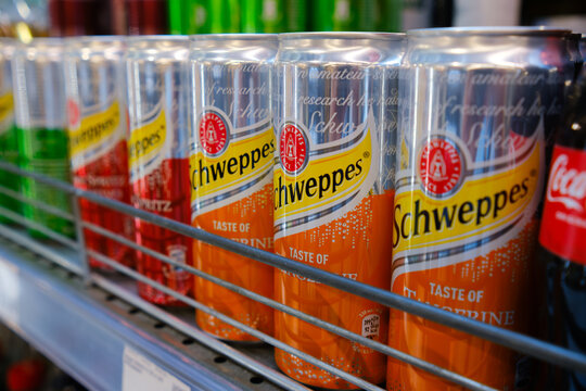 Ukraine, Odesa - September 21, 2023: Schweppes aluminum cans in a row at a supermarket.