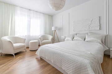 Modern bedroom in white tones with white furniture