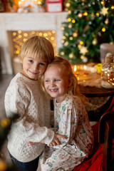 Obraz na płótnie Canvas Beautiful children, blond kids, siblings, playing in decorated home for Christmas, enjoying holidays