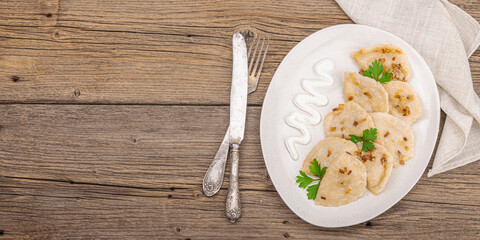 Dumplings, filled with cabbage. Fried onion, fresh sour cream. Traditional Ukrainian dish