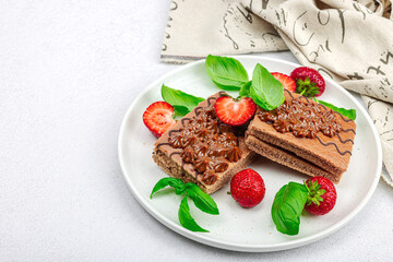 Delicious chocolate cakes with fresh strawberries. Sweet dessert, good morning concept