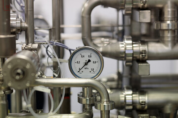 close up of stainless steel pipes and gauge
