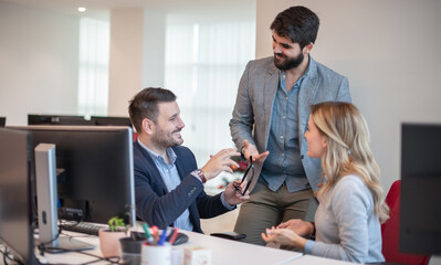 Fototapeta premium Business people laughing at funny joke in office. Friendly work team enjoying positive emotions together, happy colleagues staff group having fun at office break.