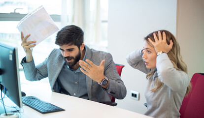 Businessman arguing and yelling at his female colleague in office. Abuse and conflict at work concept. Businesswoman with hands on head can't listen her loud superior. Business conflict. - obrazy, fototapety, plakaty
