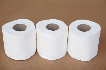 Rolls of white toilet paper, on brown background. Concept, cleaning tool, hygienic to wipe dirty and absorb wet ,use tissue paper for hygienic and sanitary in daily life.             