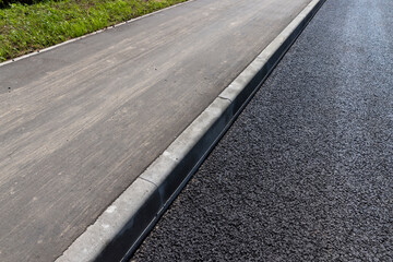 asphalting a new highway with black new asphalt