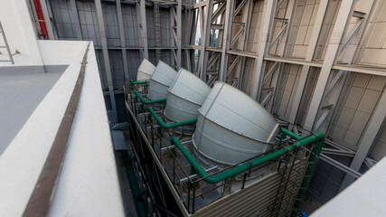 Cooling towers in data center building. Air conditioning cooling towers in front of building with...