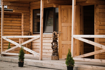 Porch and open doors of a wooden house. Concept of buying an ecological house made of wood