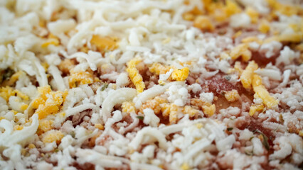 Frozen pizza with four cheese in the oven and its packaging is torn 