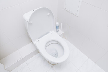 White toilet with open lid. Toilet morning procedures.