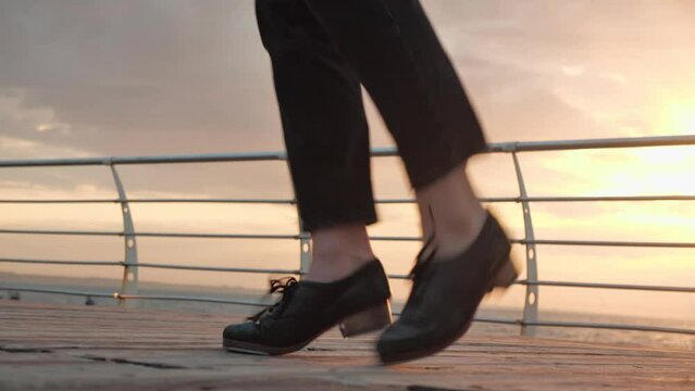 tap dancing person with sunrise sea view. Irish dancing. dancing shoes on legs