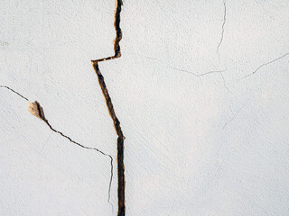 Cracks in the cement wall White cement of buildings damaged by earthquakes