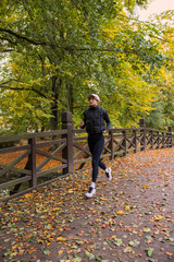 girl running in the  autumn park 