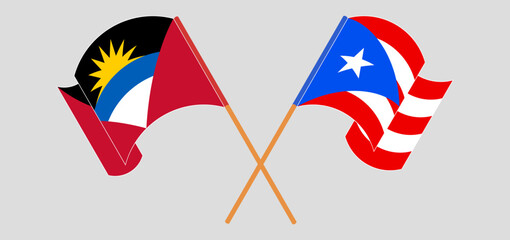 Obraz premium Crossed and waving flags of Antigua and Barbuda and Puerto Rico