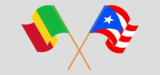 Crossed and waving flags of Mali and Puerto Rico