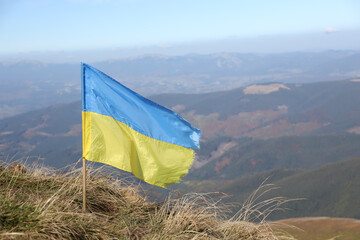 Ukrainian flag on top of Hoverla mountain in Ukraine close up